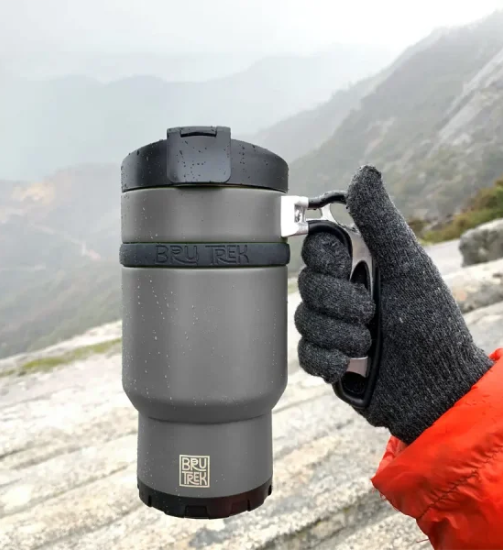 gloved hand holding travel brewer
