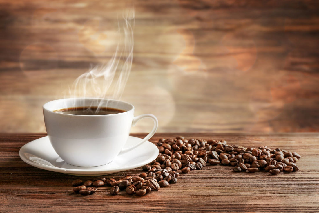 white coffee cup surrounded by coffee beans