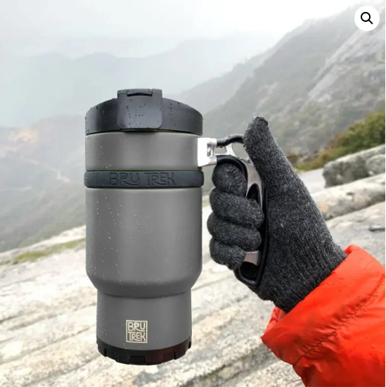 gloved hand holding travel brewer