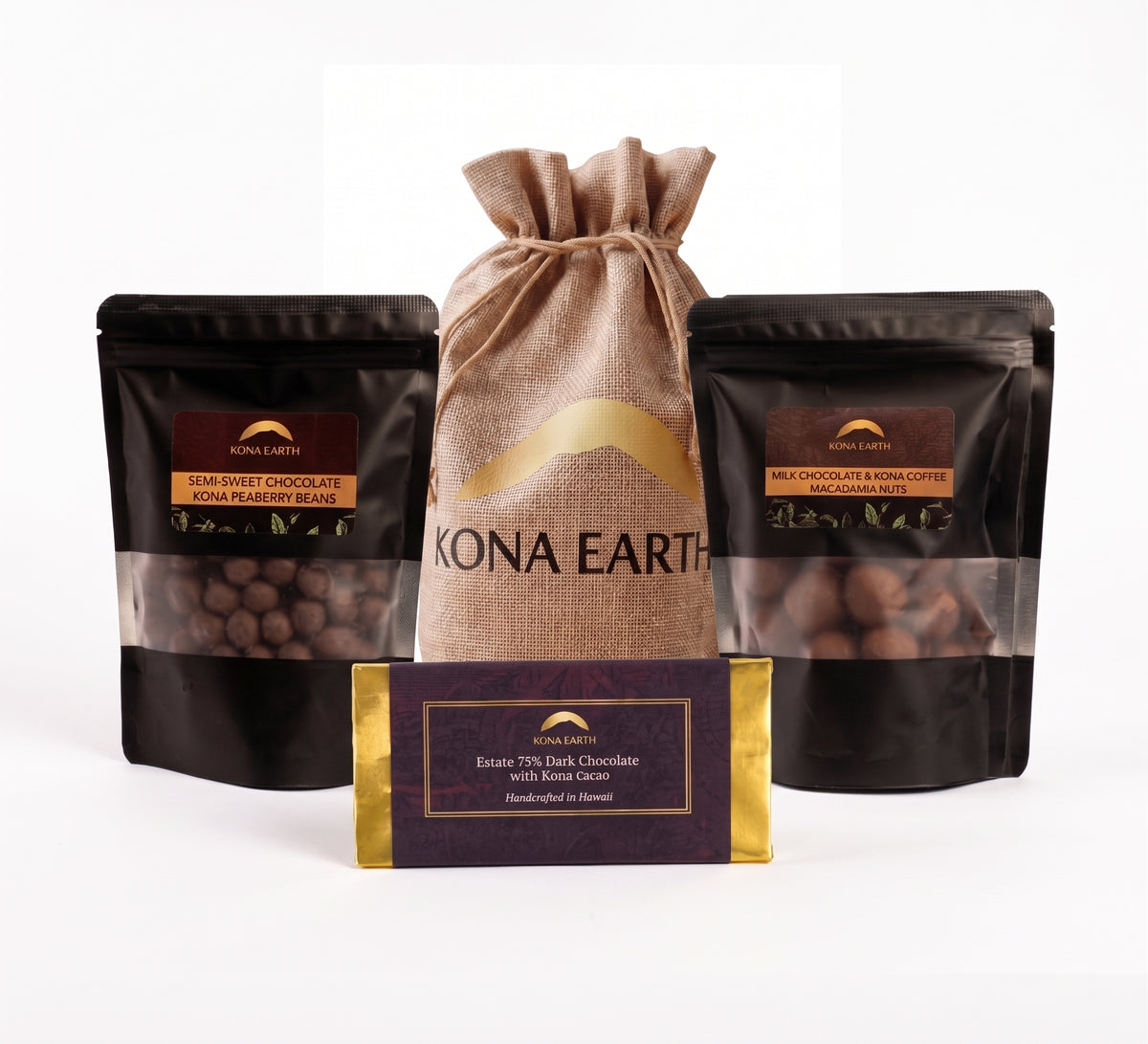 A chocolate gift set from Kona Earth, featuring two black stand-up pouches of chocolate beans (one with dark berry chocolate and one with earthy chocolate), a central tan burlap drawstring bag, and a dark purple chocolate bar with gold trim in front, all on a white background.