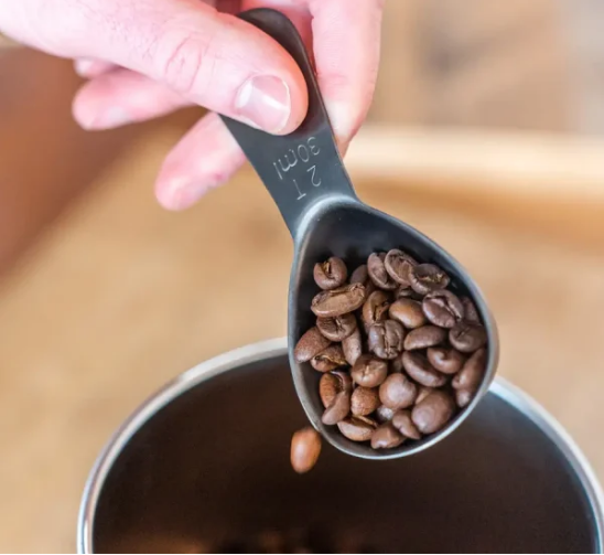hand holding coffee scoop